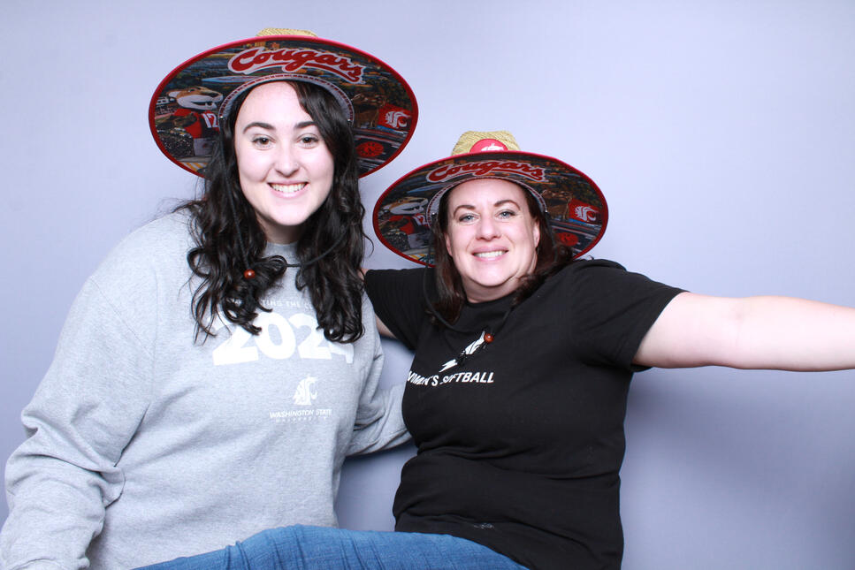A photo booth photo of a WSU college grad at her graduation party, shot on Canon Rebel T5 and a silver backdrop